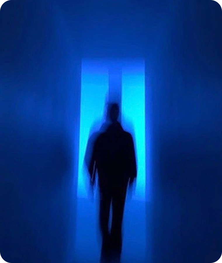 A figure silhouetted in a glowing blue doorway